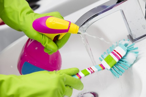 Team of cleaners following safe working practices in a workplace