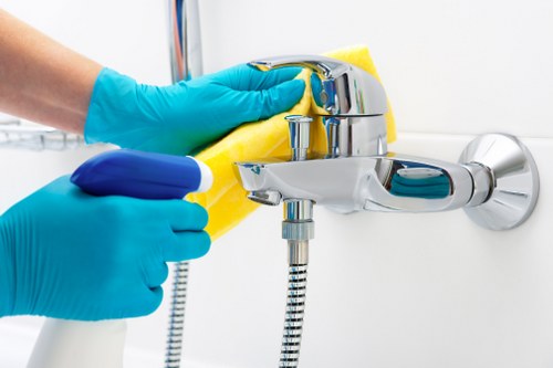 Cleaning high-touch communal surfaces in a residential building